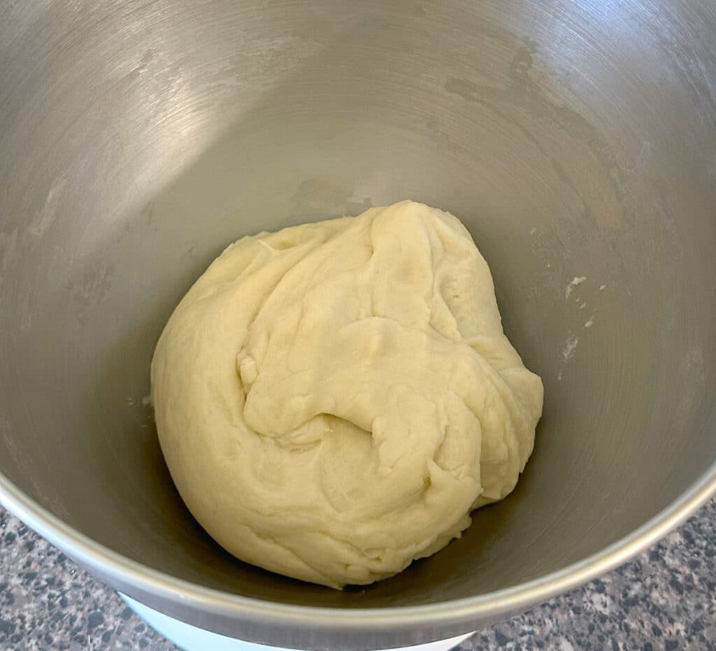 Dough for flour tortillas in the bowl of a stand mixer.