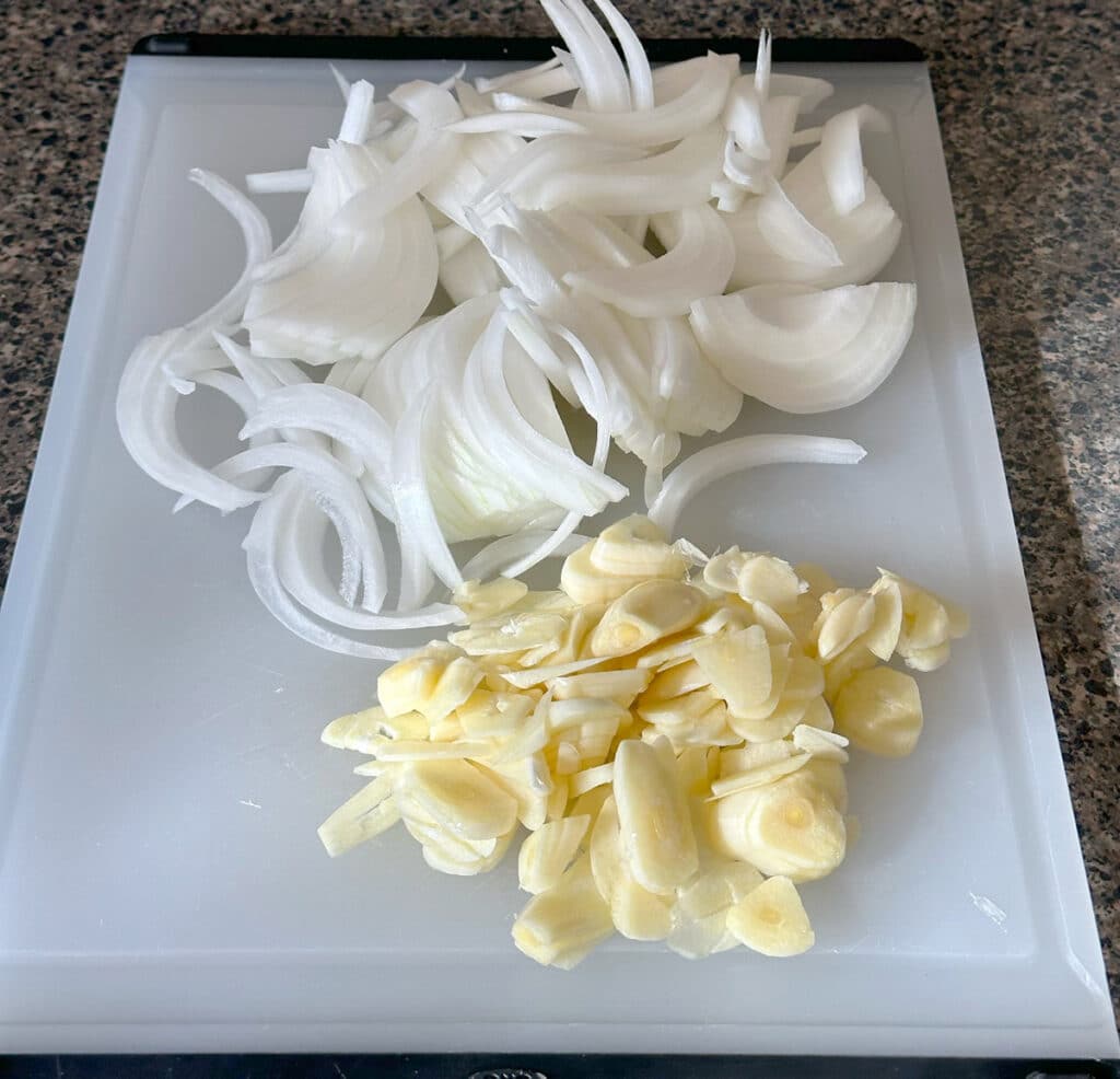 sliced onion and garlic for pork carnitas.
