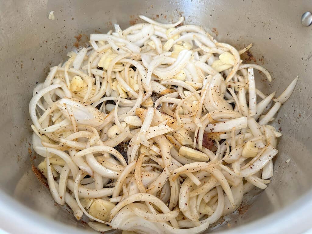 Cooking the onion and garlic for pork carnitas.