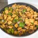 Crispy tofu stir fry in a skillet.