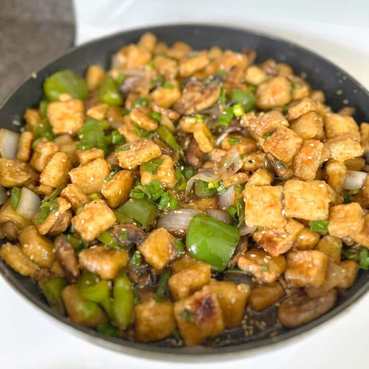 Crispy tofu stir fry in a skillet.