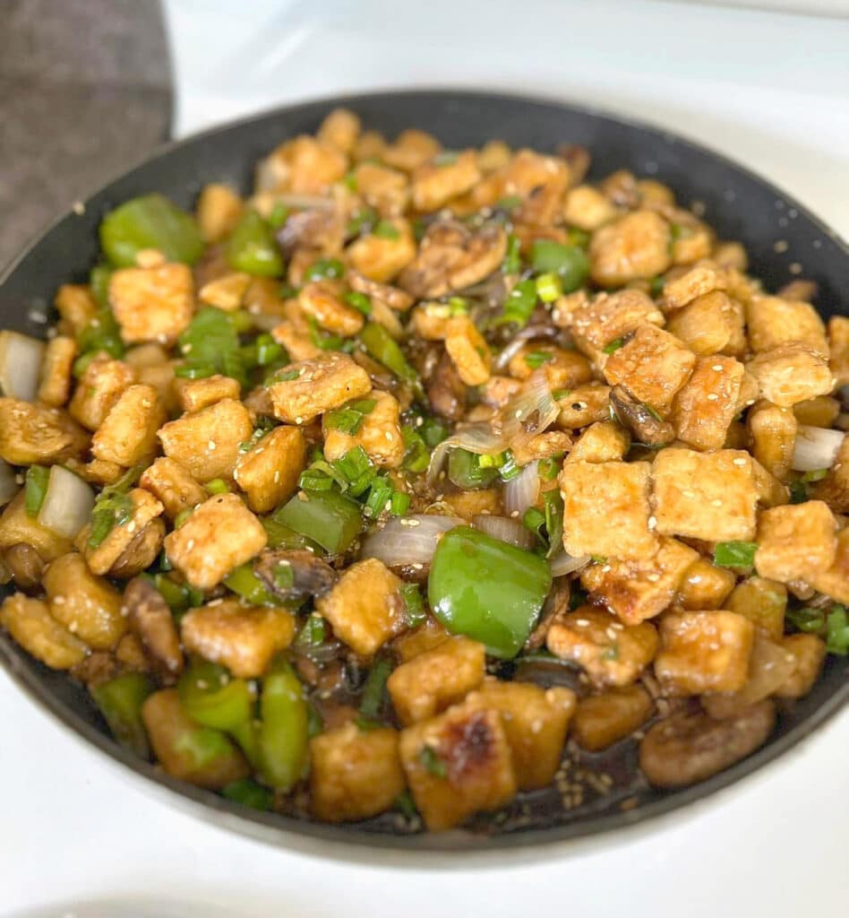 Crispy tofu stir fry in a skillet.